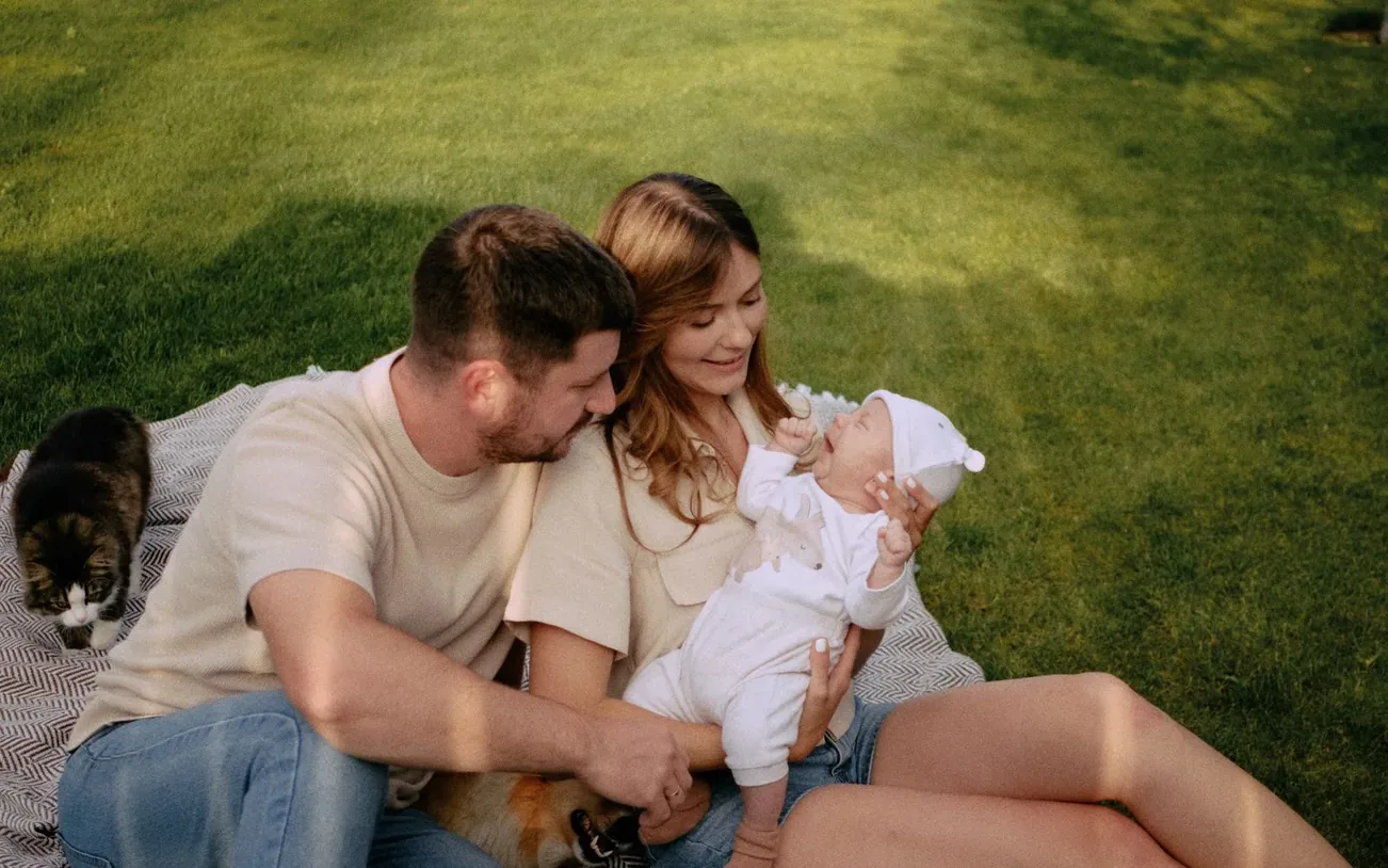 A family relaxing together on the lawn of their pest-free home in Vero Beach, FL